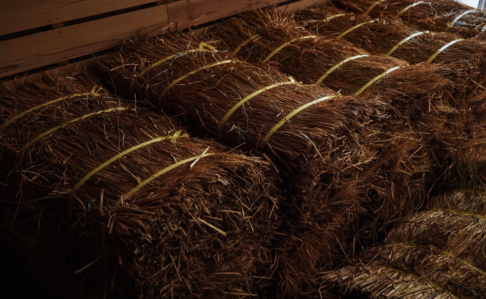 Bundles of straw stored in a wooden crate